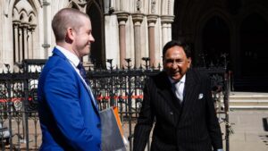 Lord Sheikh (right) and his solicitor outside the High Court in London on 30 July, after Associated Newspapers delivered their apology over the publication of a defamatory article 